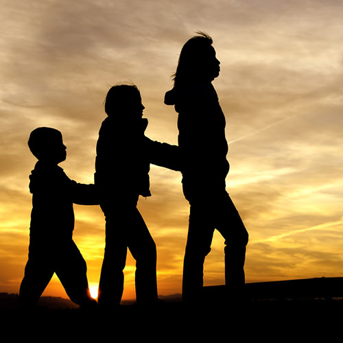 Sillhouette of children playing follow the leader